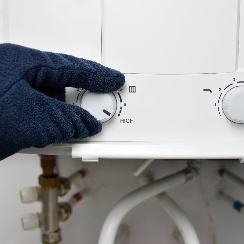 close-up of a tankless water heater being adjusted