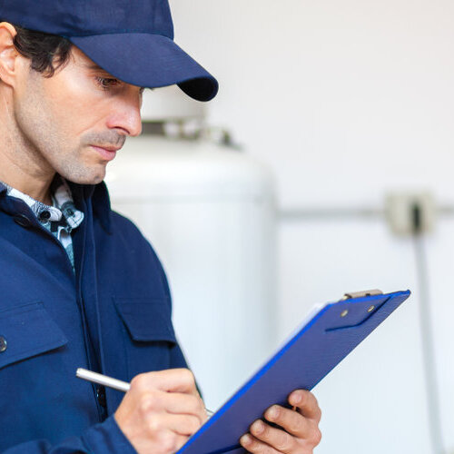 plumber making notes on a clipboard