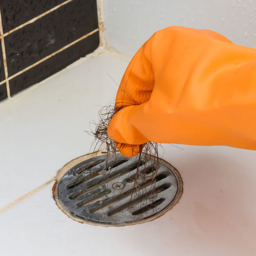Hair Being Removed From a Drain.