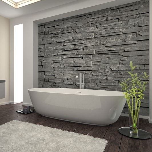 bathtub against a stone wall inlay