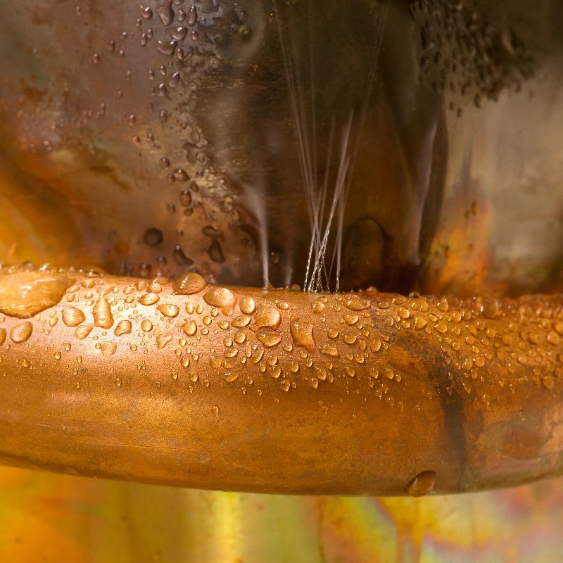 close-up of a leaking copper pipe