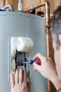 A Picture of a Man Doing Water Heater Maintenance