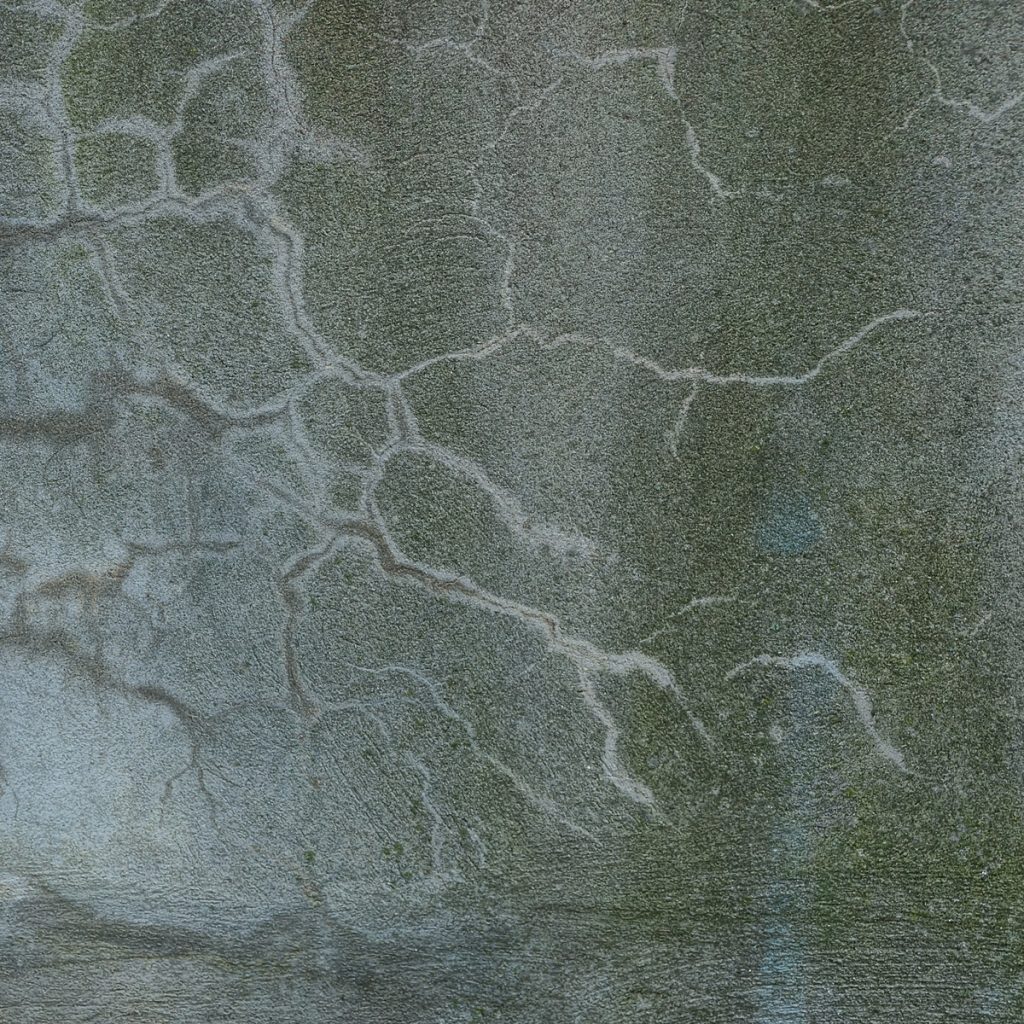 greenish concrete slab with minor cracks and patches