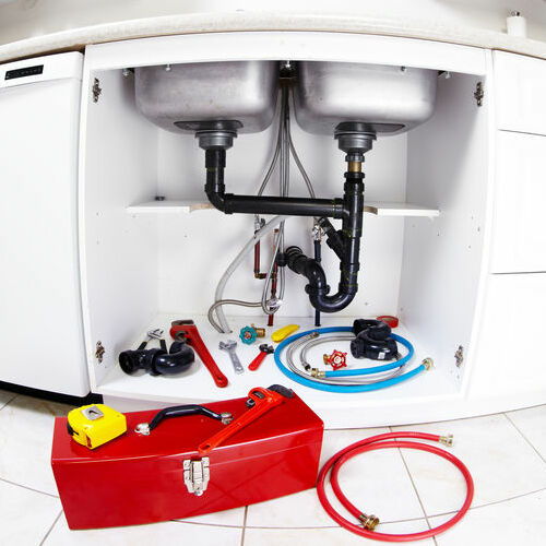 Plumber tools on the kitchen. Plumbing and renovation background.